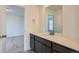 Bathroom vanity with white counter, wood cabinets, and brushed nickel fixtures at 747 Raindance St, Erie, CO 80516