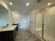 Spacious bathroom with a double vanity sink and a glass-enclosed shower at 747 Raindance St, Erie, CO 80516