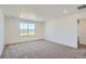 Bright bedroom featuring neutral carpet and a large window offering a scenic view at 747 Raindance St, Erie, CO 80516