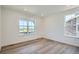 Bedroom with two large windows providing views and wood-look flooring at 747 Raindance St, Erie, CO 80516
