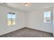 Neutral bedroom with natural light from two windows and cozy carpeting at 747 Raindance St, Erie, CO 80516