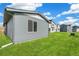 View of a home's green backyard and exterior at 9332 Bahama Ct, Commerce City, CO 80022