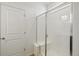 Modern bathroom features a tiled shower with glass door and built-in seat at 9332 Bahama Ct, Commerce City, CO 80022