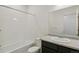 Bathroom features a shower/tub combo and vanity with a large mirror at 9332 Bahama Ct, Commerce City, CO 80022