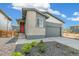 Contemporary home with a brick facade, dark trim, a red front door, and low maintenance landscaping at 9332 Bahama Ct, Commerce City, CO 80022