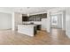 Stylish kitchen featuring dark cabinets, an island with white countertops, and an open layout, great for gatherings at 9332 Bahama Ct, Commerce City, CO 80022