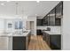 Open kitchen with large island, stainless steel appliances, modern pendant lighting, and spacious layout at 9332 Bahama Ct, Commerce City, CO 80022