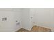 Laundry room has a door, hookups, and shelving at 9332 Bahama Ct, Commerce City, CO 80022