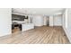 Open-concept living space with wood-look floors and seamless flow into the kitchen, great for entertaining at 9332 Bahama Ct, Commerce City, CO 80022