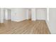 Bright living room with wood-look floors, neutral walls, and ample natural light, perfect for relaxation at 9332 Bahama Ct, Commerce City, CO 80022