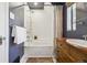 A bathroom with a tub-shower combo and wooden vanity at 629 Bellaire St, Denver, CO 80220