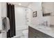 Clean bathroom with a shower-tub combo, white tile, and a marble-topped vanity at 629 Bellaire St, Denver, CO 80220