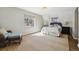 Serene bedroom with large windows, hardwood floors, and a cozy sitting area at 629 Bellaire St, Denver, CO 80220