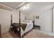 Comfortable bedroom featuring a four-poster bed, soft carpet and neutral decor at 629 Bellaire St, Denver, CO 80220
