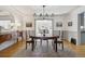 Elegant dining room with a round table set on a patterned rug beneath a modern chandelier at 629 Bellaire St, Denver, CO 80220