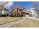 Charming two-story brick home with attached garage and beautiful stone pathway to front door at 629 Bellaire St, Denver, CO 80220