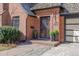 Charming brick home featuring a decorative security door, lush landscaping, and a well-maintained facade at 629 Bellaire St, Denver, CO 80220