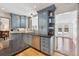 Well-lit kitchen with blue cabinets, stainless steel appliances, and an open view of the backyard pool at 629 Bellaire St, Denver, CO 80220