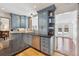 Charming kitchen featuring stylish blue cabinetry, stainless steel appliances, and elegant granite countertops at 629 Bellaire St, Denver, CO 80220