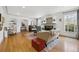 Open-concept living room featuring hardwood floors, fireplace, and large windows at 629 Bellaire St, Denver, CO 80220