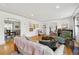 Bright living room featuring hardwood floors with views to the dining room and staircase at 629 Bellaire St, Denver, CO 80220