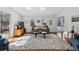 Sun-drenched living room featuring a comfortable sofa, skylights, and direct access to the outdoors, perfect for relaxing at 629 Bellaire St, Denver, CO 80220