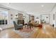 Spacious and bright living room featuring hardwood floors, fireplace, and large windows for a comfortable living space at 629 Bellaire St, Denver, CO 80220
