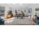 Cozy living room with skylights, a comfortable sofa, and a large rug at 629 Bellaire St, Denver, CO 80220