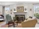 Cozy living room with a fireplace, hardwood floors, and natural light at 629 Bellaire St, Denver, CO 80220