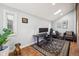 Home office featuring hardwood floors, a skylight, and an accent brick wall at 629 Bellaire St, Denver, CO 80220