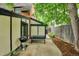 Back patio area with outdoor seating, a BBQ grill, and lush landscaping at 629 Bellaire St, Denver, CO 80220