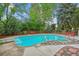 Backyard in-ground pool with diving board, hot tub, concrete and stone deck, and mature trees at 629 Bellaire St, Denver, CO 80220