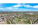 Picturesque aerial view featuring lush green landscaping, a calm body of water, and stunning mountain views in the background at 875 E 78Th Ave # 21, Denver, CO 80229