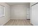 Secondary bedroom with plank floors, bright window and single door closet at 875 E 78Th Ave # 21, Denver, CO 80229