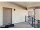 Exterior condo hallway with door to unit 21, showing outdoor light fixture and door lock system at 875 E 78Th Ave # 21, Denver, CO 80229