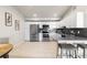 Bright kitchen features stainless appliances, white cabinets, modern countertops and stylish breakfast bar at 875 E 78Th Ave # 21, Denver, CO 80229
