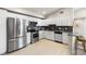 Well-lit kitchen featuring stainless steel appliances, white cabinetry, and a breakfast bar at 875 E 78Th Ave # 21, Denver, CO 80229