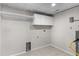 Functional laundry room with storage cabinets and tiled flooring, ready for appliances at 875 E 78Th Ave # 21, Denver, CO 80229