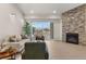 Comfortable living room featuring a stone fireplace, large sliding glass doors, and natural light at 875 E 78Th Ave # 21, Denver, CO 80229