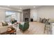 Spacious living area with fireplace, dining area, and breakfast bar; wood flooring throughout at 875 E 78Th Ave # 21, Denver, CO 80229
