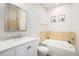 Bathroom with a vanity with granite countertop, tile backsplash, and bathtub at 9434 Ashbury Cir # 204, Parker, CO 80134