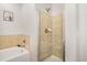 Bathroom with glass door shower and bathtub with tile surround at 9434 Ashbury Cir # 204, Parker, CO 80134
