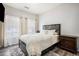 Bedroom with a large bed, wood-look floors, neutral colors, and abundant natural light at 9434 Ashbury Cir # 204, Parker, CO 80134