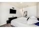 Primary bedroom with ensuite bathroom and a mounted television at 9434 Ashbury Cir # 204, Parker, CO 80134