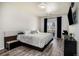 Bedroom featuring wood-look flooring, balcony access, and minimalist design at 9434 Ashbury Cir # 204, Parker, CO 80134