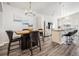 Dining area features a modern chandelier and an open view into the adjacent kitchen and stainless appliances at 9434 Ashbury Cir # 204, Parker, CO 80134