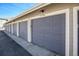 A row of garages with neutral paint and white trim providing secure parking and additional storage at 9434 Ashbury Cir # 204, Parker, CO 80134