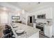 Modern kitchen featuring a spacious island with bar seating and views of the adjacent dining area at 9434 Ashbury Cir # 204, Parker, CO 80134