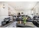 Open-concept living room flows seamlessly into dining and kitchen areas, with a leather sofa at 9434 Ashbury Cir # 204, Parker, CO 80134