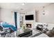 Comfortable living room features a fireplace, mounted television, and a sliding door to an outside balcony at 9434 Ashbury Cir # 204, Parker, CO 80134